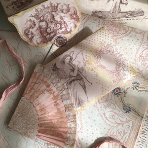 May include: A collection of vintage paper ephemera with a pink and gold color scheme. The papers feature images of angels, cherubs, and a fan. The text on the papers includes "Republique", "Liberte", "Francaise", and "Egalite".