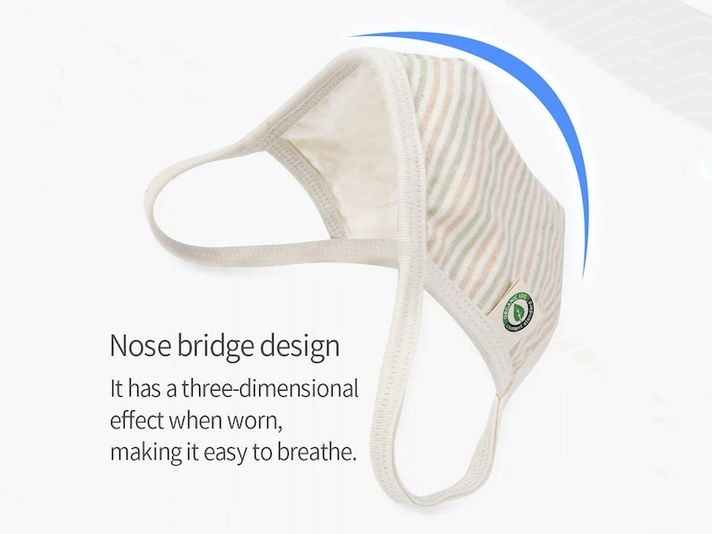 May include: A white and beige striped face mask with a nose bridge design. The mask has a green leaf logo on the side. "Nose bridge design It has a three-dimensional effect when worn, making it easy to breathe." text is below the mask.