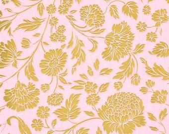 May include: A pink background with a repeating pattern of gold floral designs. The flowers are stylized and have a delicate, intricate look.