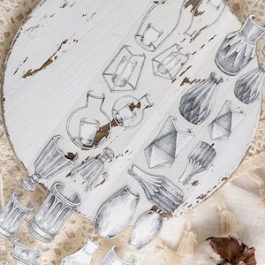 May include: A selection of black and white line art illustrations depicting diverse vases and vessels. The drawings showcase various shapes and styles, including geometric, rounded, and detailed designs. The illustrations are arranged on a white, distressed wooden surface.