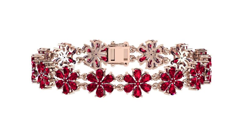 May include: A rose gold bracelet with a floral pattern. The flowers are set with bright red gemstones. The bracelet has a clasp closure and is shown against a white backdrop.