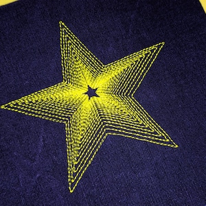 May include: A yellow star embroidered on a dark blue fabric background.