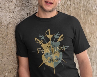 May include: A black t-shirt with a graphic design of swords and a shield. The text on the shirt reads "The Art of Fencing is Dueling in Defense."