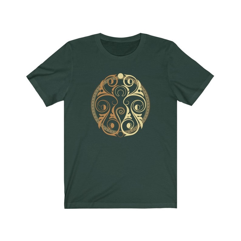 May include: A dark green t-shirt with a gold and brown circular design featuring intricate swirls and patterns.