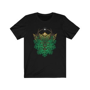 May include: Black t-shirt with a green and gold Green Man design. The Green Man is a mythical figure often depicted with a face surrounded by leaves and branches.