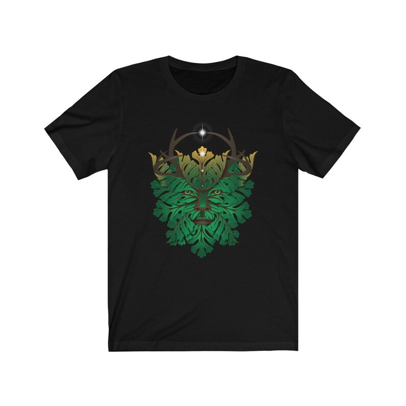 May include: Black t-shirt with a green and gold Green Man design. The Green Man is a mythical figure often depicted with a face surrounded by leaves and branches.