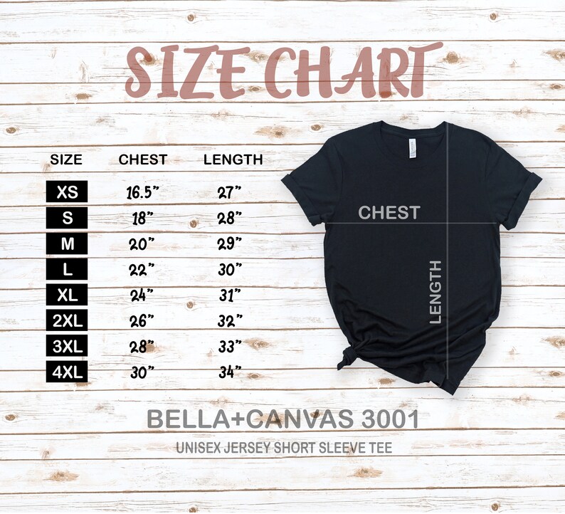 May include: Size chart for a unisex jersey short sleeve tee, showing chest and length measurements in inches for sizes XS to 4XL. The chart is on a woodgrain background with a black t-shirt displayed on top.