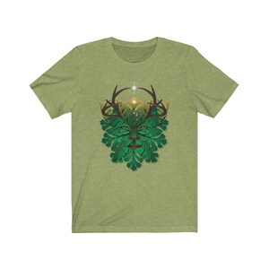 May include: A green and gold t-shirt with a graphic of the Green Man, a mythical figure with a face made of leaves and antlers.