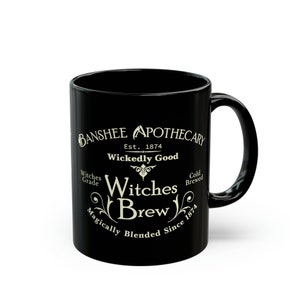 May include: Black ceramic mug with a white design that reads "Banshee Apothecary Est. 1874 Wickedly Good Witches Brew Magically Blended Since 1874"