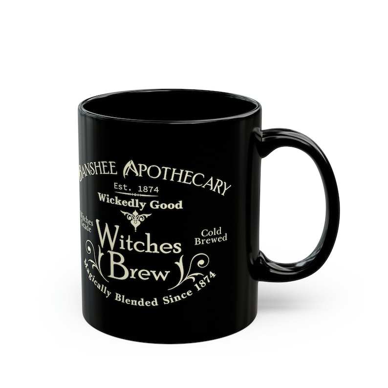 May include: Black ceramic mug with a white design that reads "Banshee Apothecary Est. 1874 Wickedly Good Witches Brew Magically Blended Since 1874 Cold Brewed".