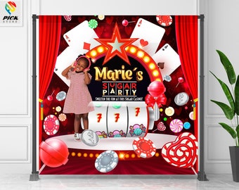May include: A backdrop for a party with a casino theme. The backdrop features a red background with playing cards, candies, and a slot machine. The text "Marie's Sugar Party" is displayed. A young girl is wearing a pink dress and headphones.