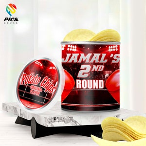 May include: A can of potato chips with the text "JAMAL'S 2ND ROUND" and a container of potato chips with the text "Potato Chips ORIGINAL FLAVOR". The can has a red and black design with boxing gloves.