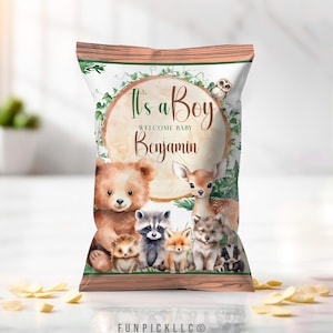 May include: Chip bag favor with a woodland theme. It says "It's a Boy" and "Welcome Baby Benjamin". The bag features a brown bear, a raccoon, a fox, a wolf, a deer, and a hedgehog.