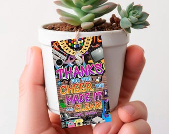 May include: A colorful thank you card with a 90s theme featuring a gold chain, a Rubik's cube, a boombox, a television, and a video game controller. The text on the card reads "Thanks for the cheer, you made it all clear! Love, Sasha".