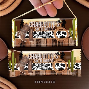 May include: Two candy bar wrappers with a rodeo theme. The wrappers feature brown cowboy boots, a silhouette of a person, a cactus, and the text "CHARLOTTE'S 50TH RODEO Party!" on a wooden background with a cow print.