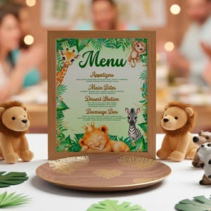 A framed menu with a jungle-themed design, featuring illustrations of animals such as a giraffe, lion, and zebra, is displayed on a table surrounded by stuffed animals.