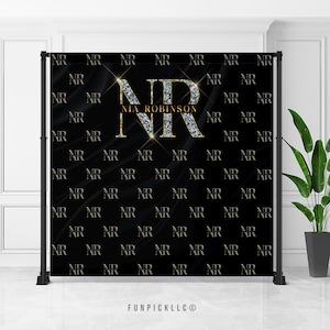 May include: Black backdrop with a large gold and diamond-encrusted "NR" monogram. The letters are surrounded by a gold outline and the text "NIA ROBINSON" is written in gold below the monogram. The background is covered in a repeating pattern of the letters "NR" in gold.
