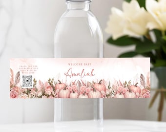 May include: Water bottle label with a pink and white floral design and pumpkins. The label says "Welcome Baby Amaliyah" and includes a QR code.