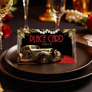 Puede incluir: Una tarjeta de mesa negra con detalles dorados Art Déco y las palabras "PLACE CARD" en purpurina roja. Un coche antiguo dorado aparece en la tarjeta, con el número de mesa "0" debajo. La tarjeta está colocada sobre un plato oscuro.