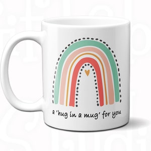 May include: White ceramic mug with a rainbow design and the text 'a'hug in a mug' for you'. The mug has eight color options for the handle and interior.
