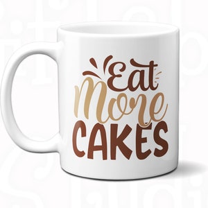 May include: White ceramic mug with a brown and gold design that says "Eat More Cakes". The mug has a black handle and interior color options are shown in the image.