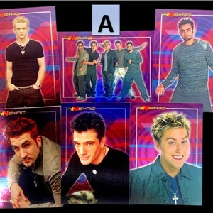 May include: Five trading cards featuring members of the boy band *NSYNC. Each card has a holographic background with the band's name and a picture of a different band member. The cards are in good condition.