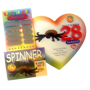 May include: A Beanie Baby trivia game card with questions and answers. The card features a black and orange spider with the text "Spinner the Spider" and "Beanie Babies Series I 4036 1998".