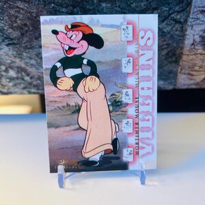 May include: A trading card featuring Mortimer Mouse from Disney's Mickey's Rival series. Mortimer is depicted in a green and white striped shirt, tan pants, and a red hat. The card has the Disney Treasures logo.