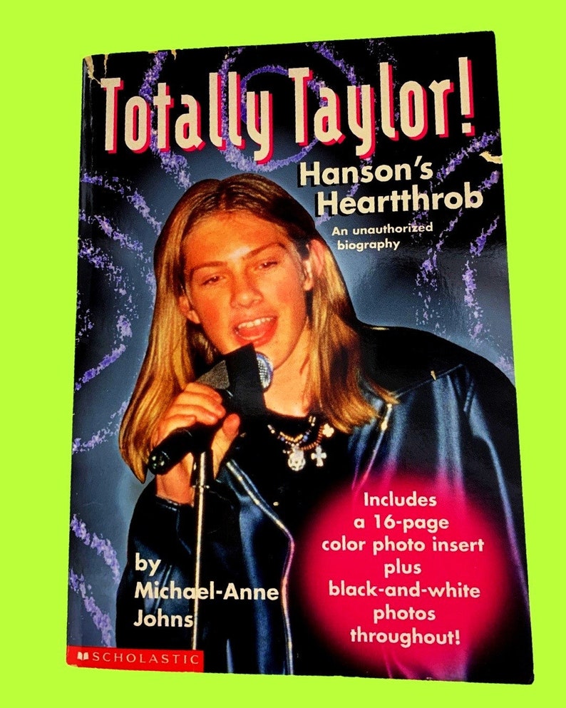 May include: A book cover titled "Totally Taylor! Hanson's Heartthrob" features a young person holding a microphone. The cover includes text that reads "An unauthorized biography" and "Includes a 16-page color photo insert plus black-and-white photos throughout!"