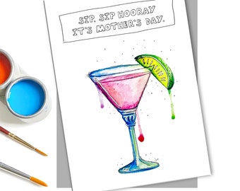 May include: A white card with black text that reads "Sip, Sip Hooray It's Mother's Day."  A pink cocktail with a lime wedge is illustrated on the card.