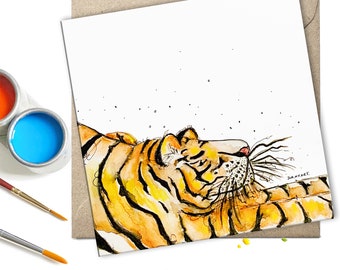 May include: Watercolor painting of a tiger lying on its back with its paws in the air. The tiger is orange and black with white stripes. The background is white with small black dots.