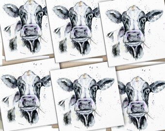 May include: Set of six blank greeting cards featuring a watercolor illustration of a black and white cow with a pink nose. The cow is looking directly at the viewer with a friendly expression.