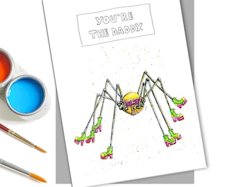 May include: A greeting card with a yellow and green spider wearing pink high heels. The card says "You're the Daddy."