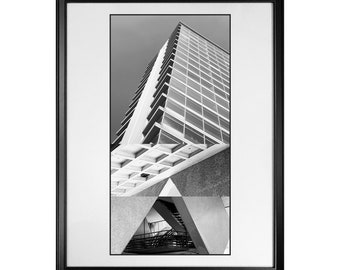 May include: Black and white photograph of a modern building with a geometric design. The building is framed by a black frame.