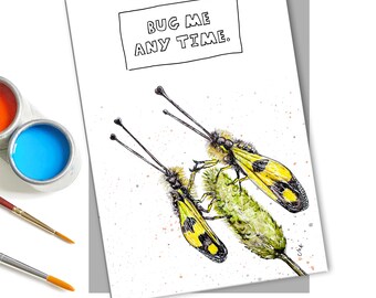 May include: A white greeting card with a black border around the text "Bug me any time."  Two yellow and black insects are drawn on the card, with long antennae, and are perched on a green plant.