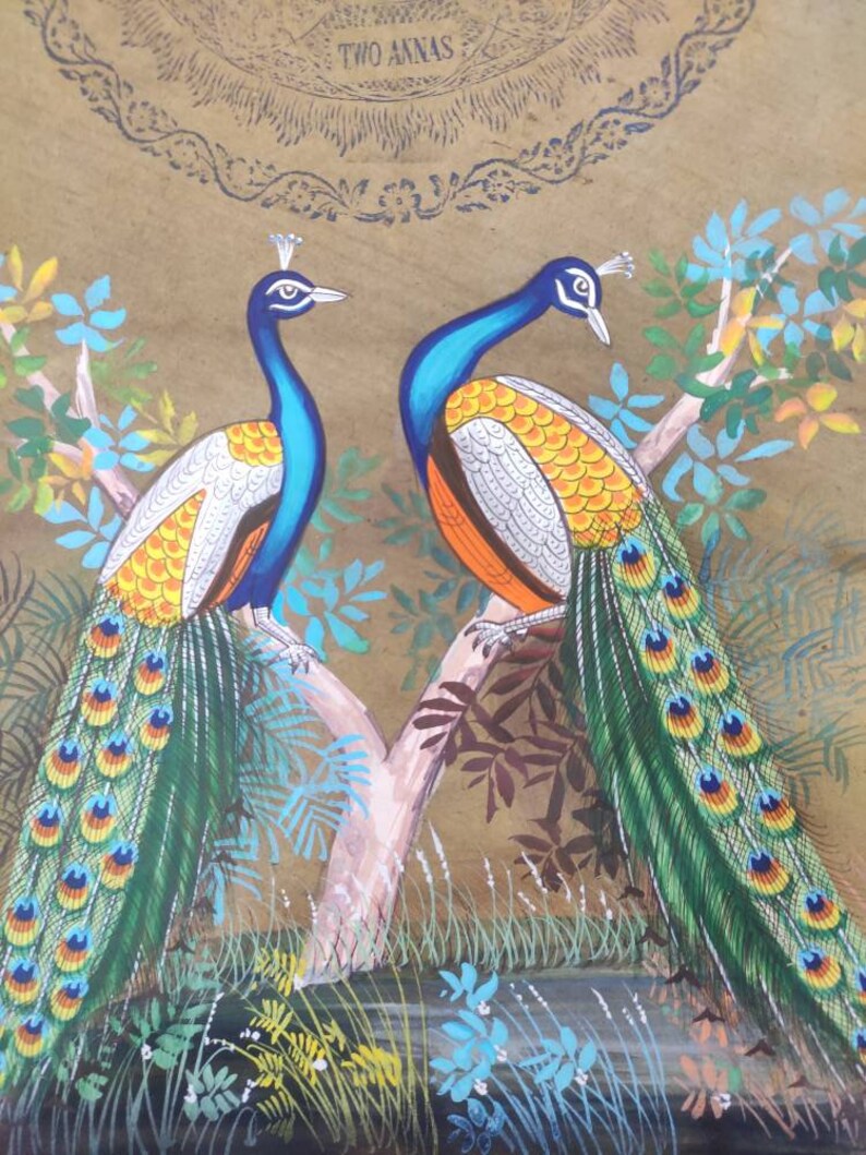 May include: A detailed painting of two peacocks perched on a tree branch. The birds have blue necks, white and orange chests, and vibrant green and yellow tail feathers. The background is a warm brown with floral accents and the text "TWO ANNAS".