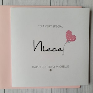 May include: A white card with pink trim and a pink heart balloon with white polka dots. The card says "To a very special Niece Happy Birthday Michelle".