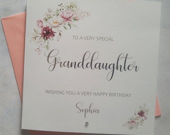 May include: A white card with a floral design in pink and green. The card says "To a very special Granddaughter Wishing you a very happy birthday Sophia".