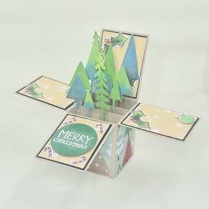 Caja de cartón desplegable en 3D con árboles de Navidad hechos a mano