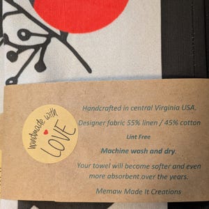 May include: A brown paper tag with the text "handmade with LOVE" in a circle with a red heart. The tag also includes the text "Handcrafted in central Virginia USA, Designer fabric 55% linen / 45% cotton Lint Free Machine wash and dry. Your towel will become softer and even more absorbent over the years. Memaw Made It Creations."