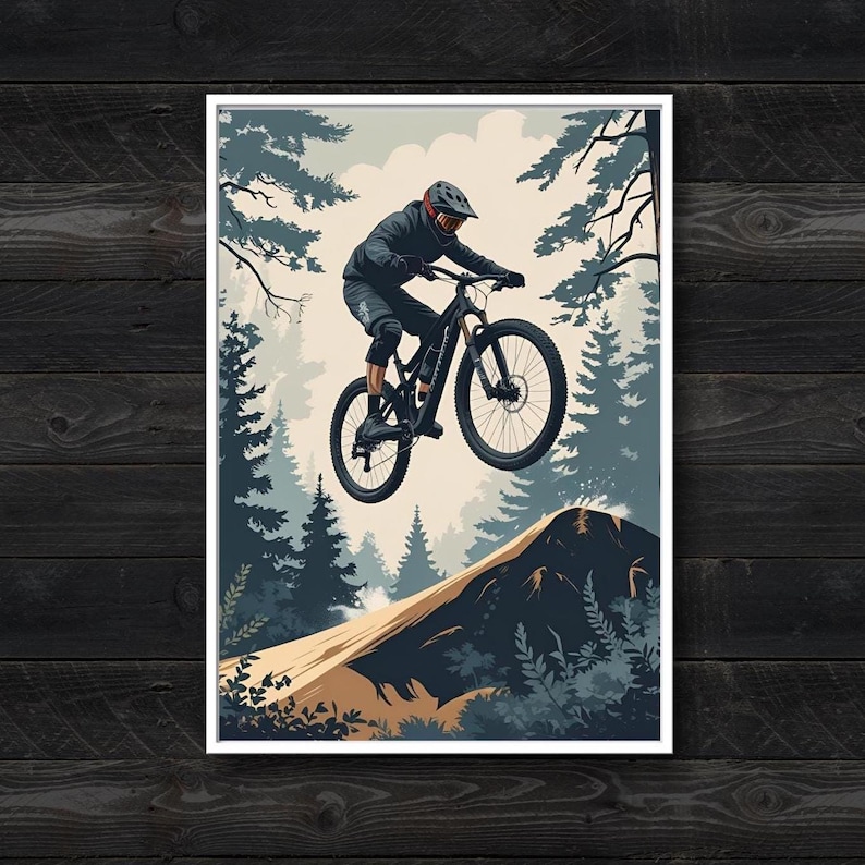 Puede incluir: Una l&aacute;mina de arte mural enmarcada con una ilustraci&oacute;n estilizada de un ciclista de monta&ntilde;a con casco y equipo oscuro saltando con una bicicleta negra sobre un mont&iacute;culo de tierra, frente a pinos en tonos azules y un cielo p&aacute;lido.
