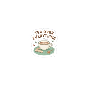 May include: A sticker featuring a cup of tea with heart-shaped foam art, a scarf, and a honey dipper. The text "TEA OVER EVERYTHING" is above the cup. The design is on a green plate with leaves.