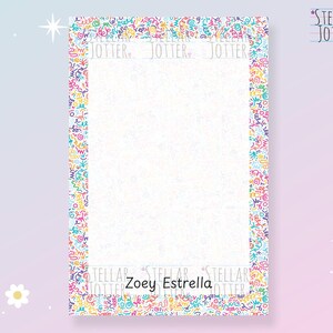 May include: A rectangular notepad with a white interior and a colourful border featuring abstract shapes in various colours. The notepad has the text "JOTTER" repeated at the top and "Zoey Estrella" at the bottom. The Stellar Jotter logo is in the upper right corner.