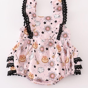 May include: Pink Halloween romper featuring pumpkins, ghosts, stars, flowers, and brooms. Black lace trim edges the romper and ruffled sleeves. A festive outfit for babies and toddlers. The measurements are in centimetres.