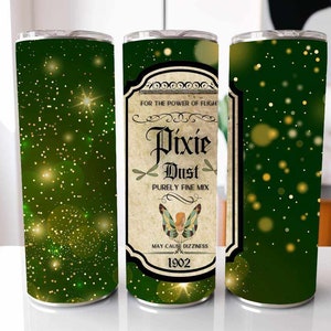 May include: Green tumbler with a gold glitter background and a label that reads "FOR THE POWER OF FLIGHT Pixie Dust PURELY FINE MIX MAY CAUSE DIZZINESS 1902".