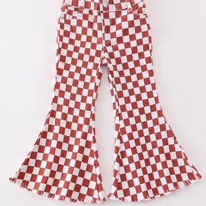 May include: Red and white checkered flared pants with a frayed hem.