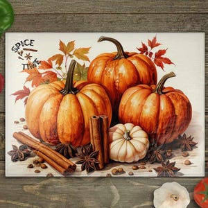May include: A white cutting board with the text "Spice Time" in a brown circle. Three orange pumpkins, cinnamon sticks, and star anise are arranged on the board.