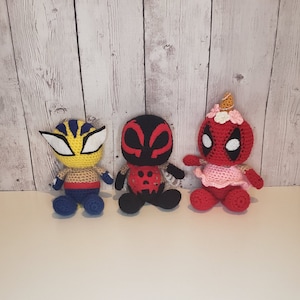 May include: Three crocheted stuffed toys: a yellow and black Wolverine, a red and black Spiderman, and a red and white Deadpool.