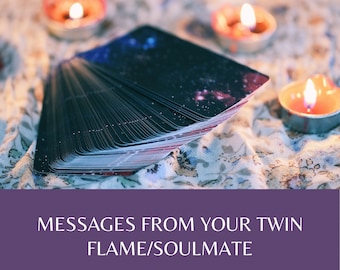 May include: A deck of tarot cards with a starry night design, resting on a floral patterned fabric with lit candles nearby. The text "MESSAGES FROM YOUR TWIN FLAME/SOULMATE" is displayed on a purple background.