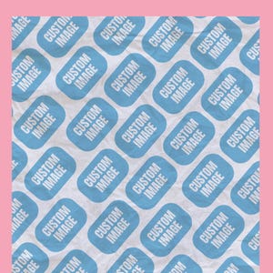 May include: A repeating pattern of light blue rectangles with rounded corners, each containing the words "CUSTOM IMAGE" in white text, against a textured white background. The background is framed by a pink border. The design is likely for custom printing.